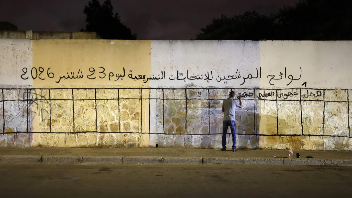 A man preparing a wall with a grid for candidates' posters for the Moroccan legislative elections on September 23, 2026.